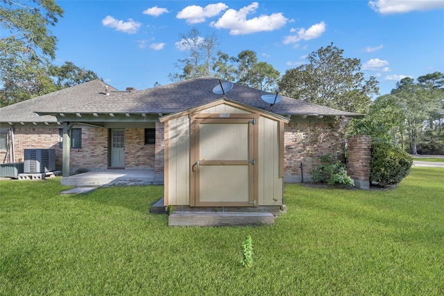 view of outdoor structure with a yard and cooling unit