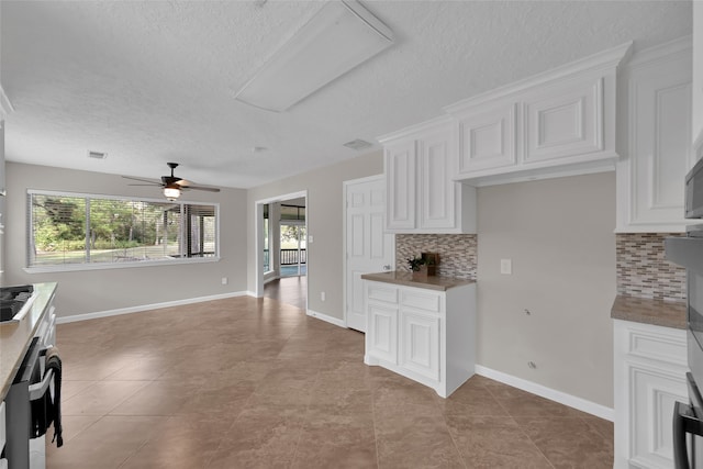 kitchen with white cabinetry, tasteful backsplash, plenty of natural light, and ceiling fan