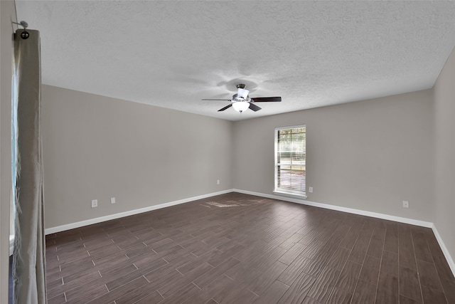 empty room with dark hardwood / wood-style floors, a textured ceiling, and ceiling fan