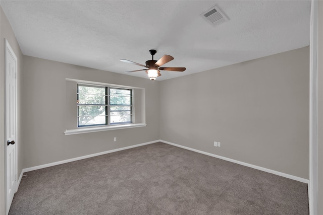 empty room with a textured ceiling, carpet, and ceiling fan