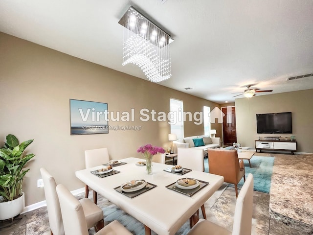 dining room with ceiling fan with notable chandelier