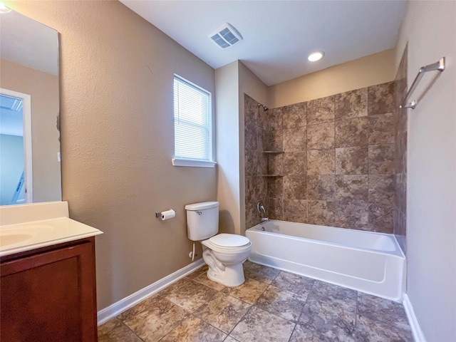 full bathroom with vanity, tiled shower / bath combo, and toilet