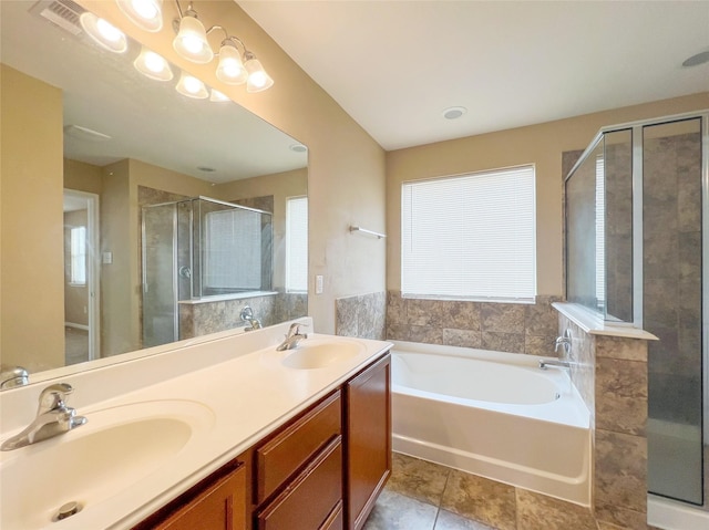 bathroom featuring vanity, a healthy amount of sunlight, separate shower and tub, and tile patterned flooring