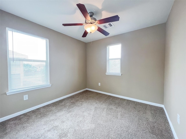 empty room featuring carpet floors and ceiling fan