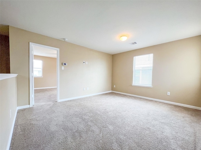 spare room with light colored carpet