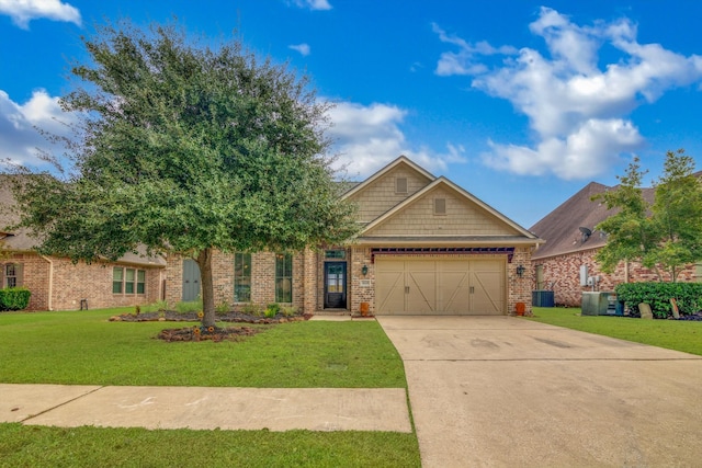 view of front of house featuring a front yard, central AC unit, and a garage