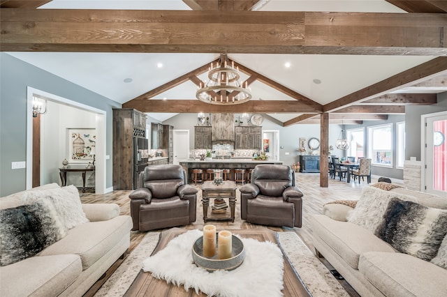 living room featuring light wood-type flooring, lofted ceiling with beams, and a chandelier