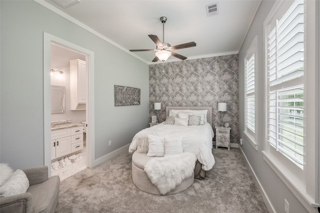 bedroom featuring ornamental molding, light carpet, ceiling fan, and connected bathroom