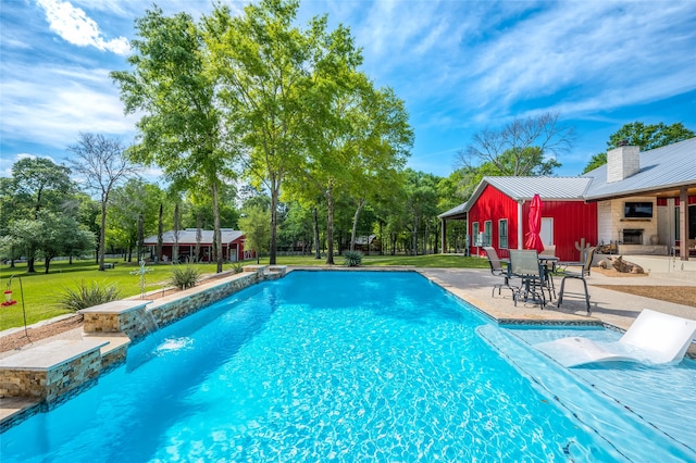 view of pool with a patio and a yard