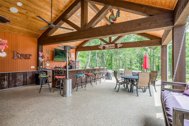 view of patio with exterior bar, ceiling fan, and a gazebo