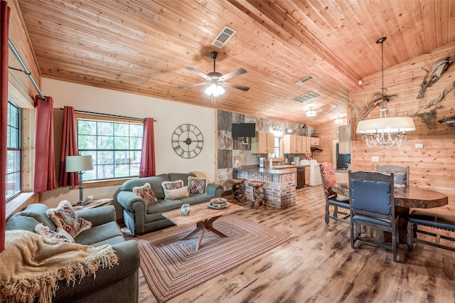 living room featuring wooden walls, wood ceiling, light hardwood / wood-style floors, lofted ceiling, and ceiling fan with notable chandelier