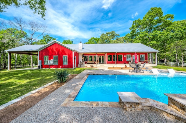 view of pool with a patio area and a yard