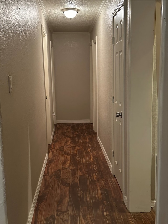 corridor with dark wood-type flooring and a textured ceiling