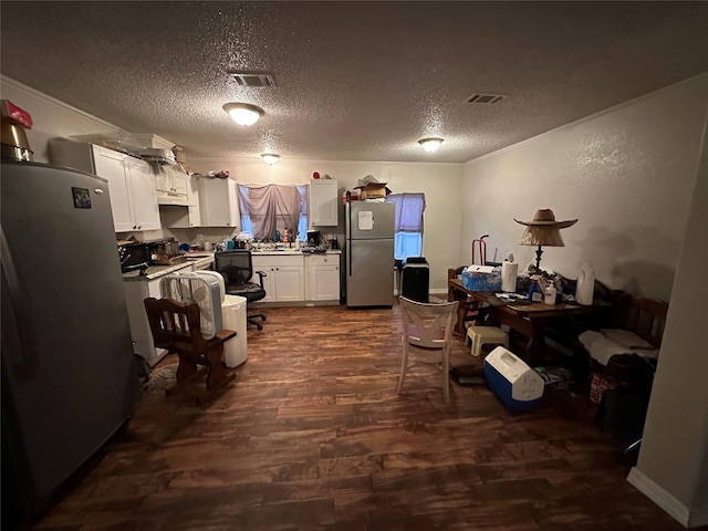 kitchen with dark hardwood / wood-style flooring, white cabinetry, a textured ceiling, and stainless steel refrigerator