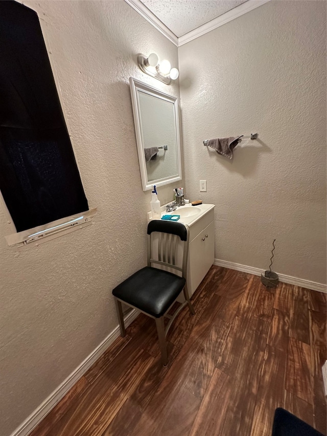 bathroom featuring vanity, ornamental molding, and hardwood / wood-style flooring