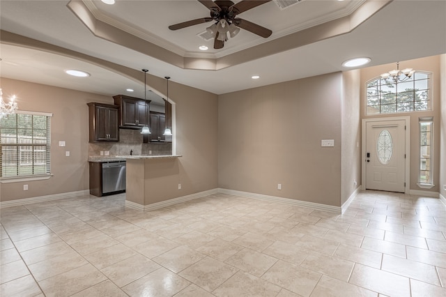 kitchen with dishwasher, dark brown cabinetry, crown molding, and a raised ceiling