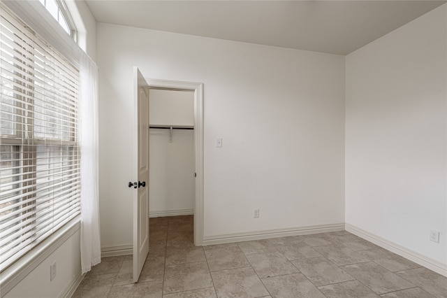 unfurnished bedroom with a closet and a walk in closet