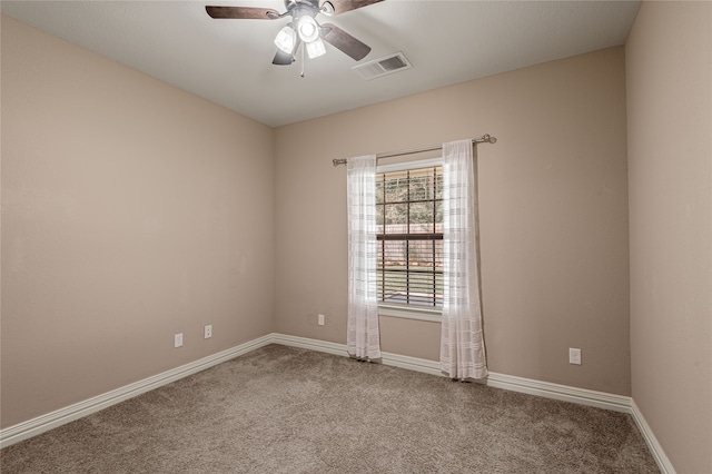 spare room featuring ceiling fan and carpet flooring