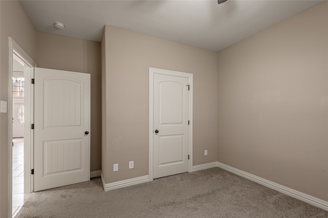 unfurnished bedroom with light colored carpet