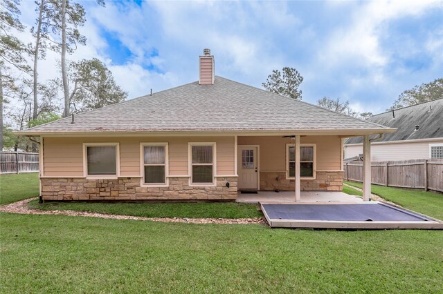 rear view of property with a lawn