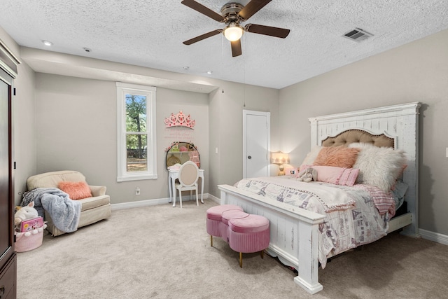 carpeted bedroom featuring a textured ceiling and ceiling fan