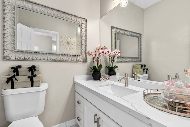 bathroom featuring toilet and vanity