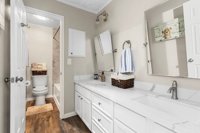 full bathroom featuring a textured ceiling, hardwood / wood-style floors, toilet, shower / bath combination, and vanity