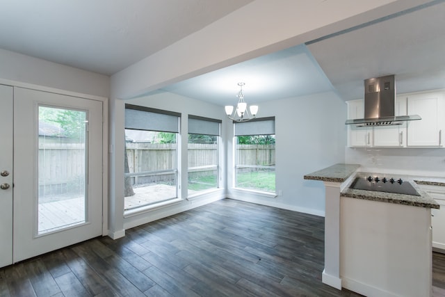 kitchen featuring exhaust hood, white cabinetry, black electric cooktop, dark hardwood / wood-style floors, and pendant lighting