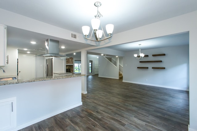 kitchen with light stone countertops, sink, white cabinetry, and dark hardwood / wood-style floors