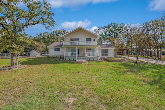 view of front of home featuring a porch, a front yard, and a balcony