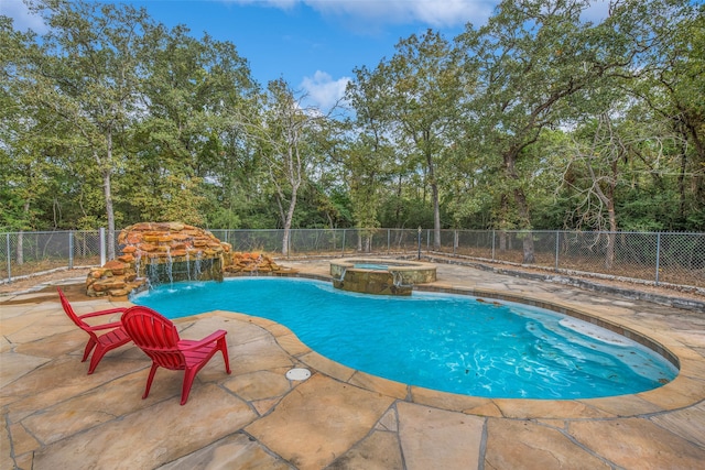 view of pool featuring a patio area, pool water feature, and an in ground hot tub