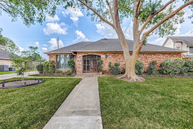 ranch-style home with central AC and a front lawn