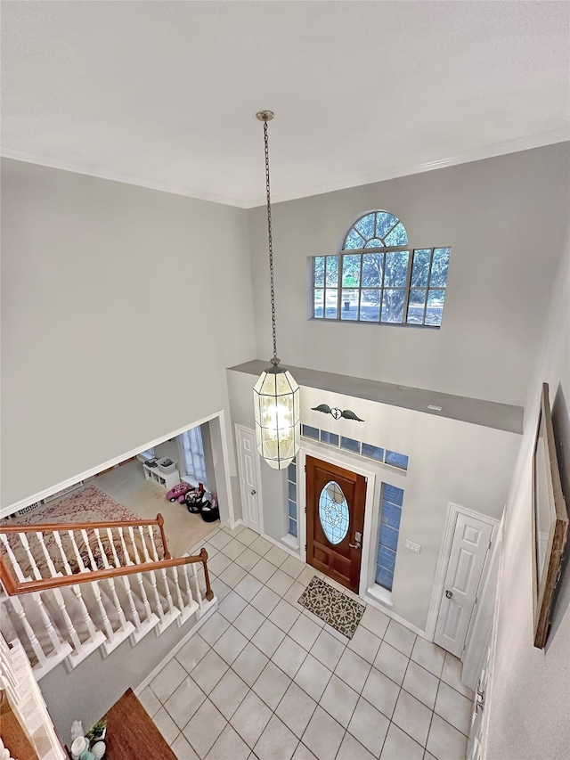 foyer featuring light tile patterned flooring and a chandelier