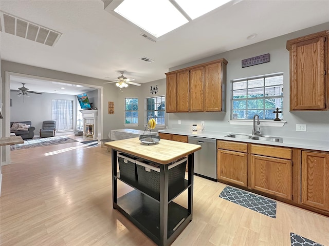 kitchen with dishwasher, a healthy amount of sunlight, and sink