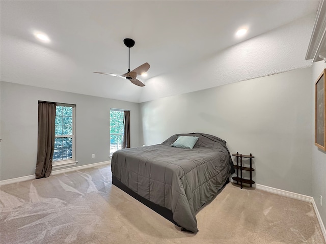 bedroom with ceiling fan and light carpet