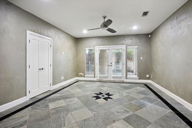 empty room featuring french doors and ceiling fan