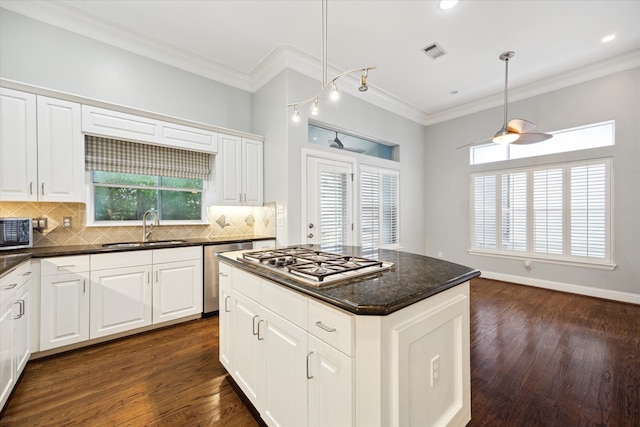 kitchen with white cabinets, dark hardwood / wood-style floors, sink, and appliances with stainless steel finishes