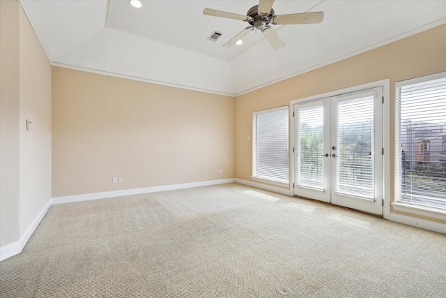 carpeted spare room featuring ornamental molding, french doors, ceiling fan, and a raised ceiling