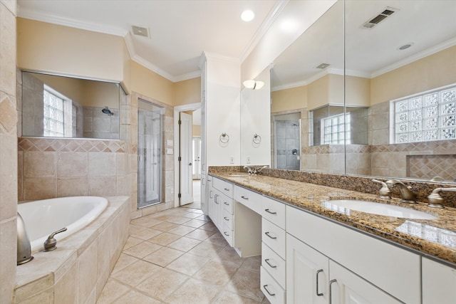 bathroom featuring plus walk in shower, vanity, tile patterned floors, and crown molding