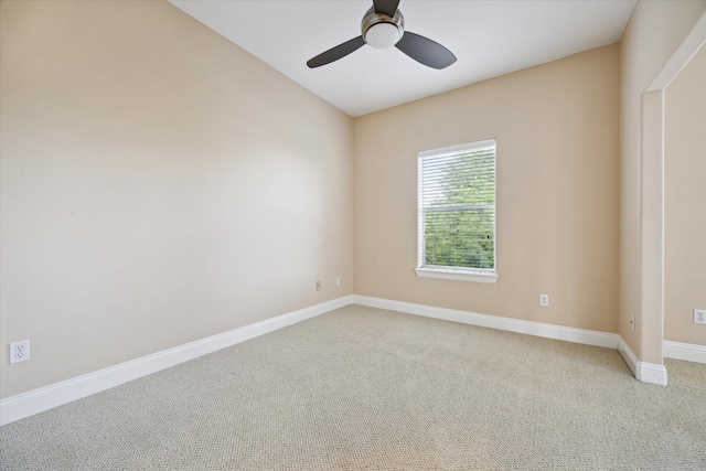 carpeted spare room with ceiling fan