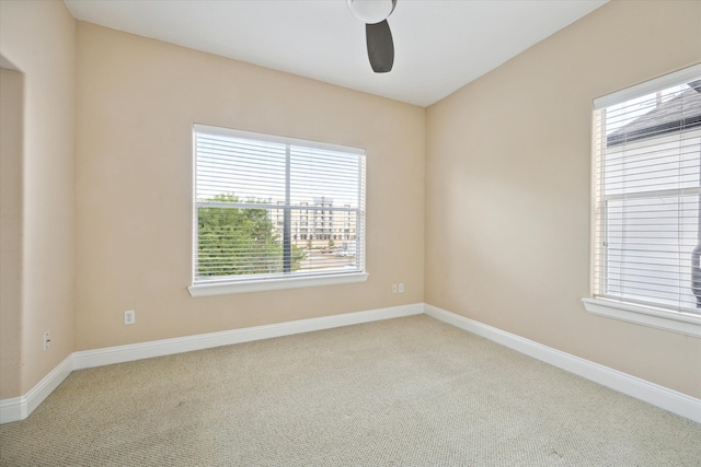 carpeted empty room featuring ceiling fan