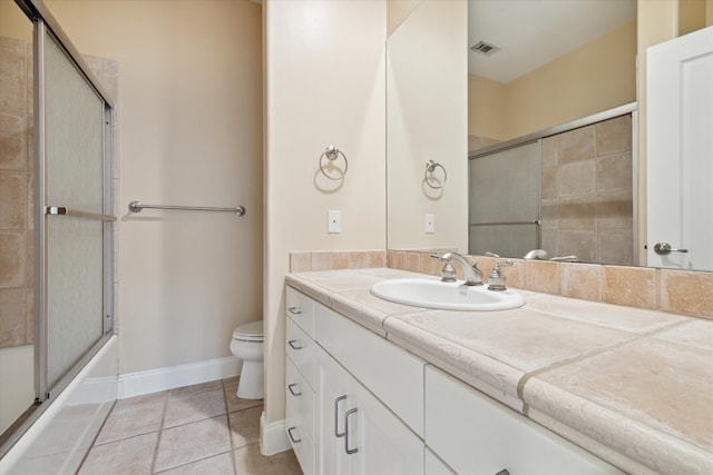 full bathroom featuring shower / bath combination with glass door, tile patterned floors, toilet, and vanity