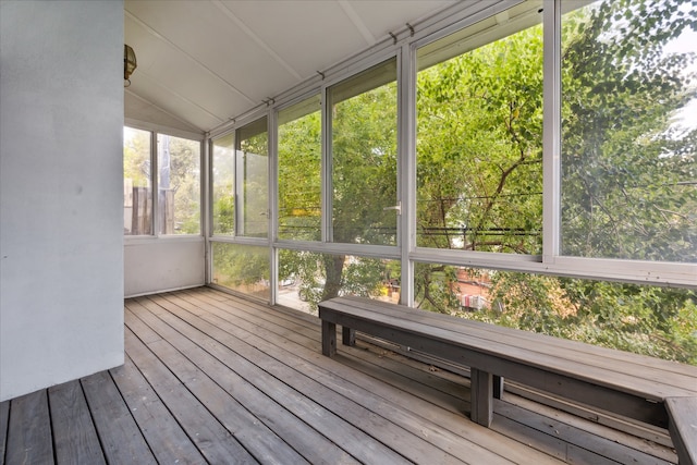 unfurnished sunroom featuring lofted ceiling