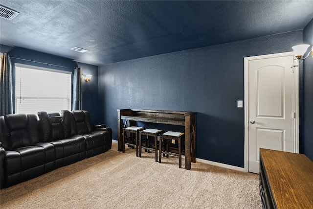 living room featuring a textured ceiling and light carpet