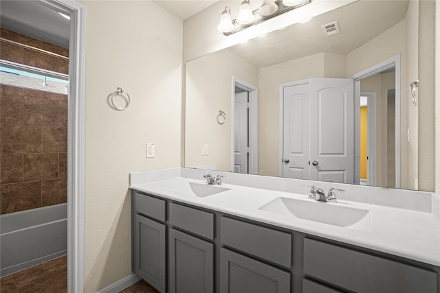 bathroom featuring a washtub and vanity