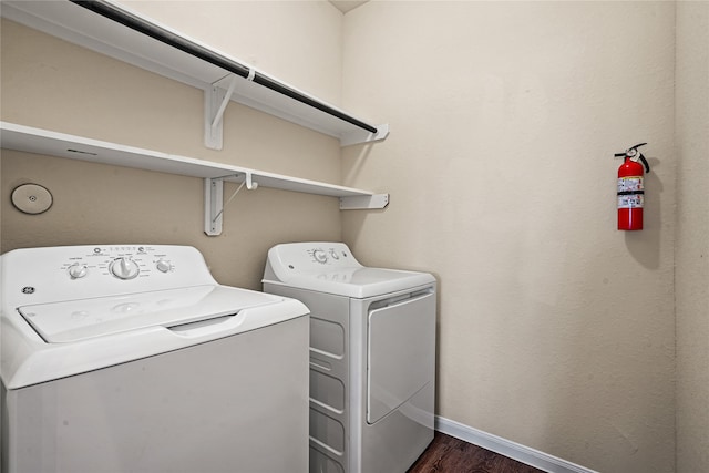 laundry area featuring dark hardwood / wood-style flooring and washing machine and clothes dryer