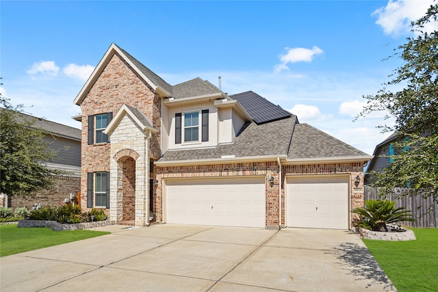 front of property with a front yard and a garage