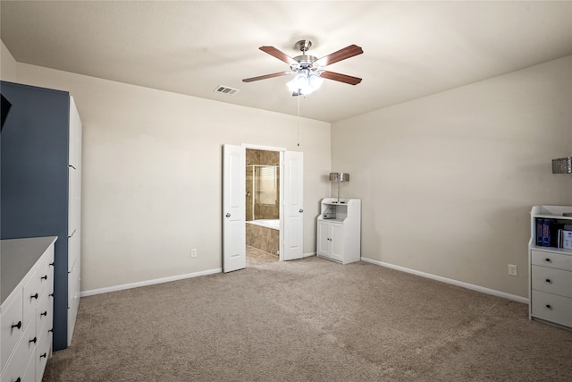 unfurnished bedroom featuring ceiling fan, connected bathroom, and light carpet