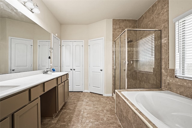 bathroom featuring shower with separate bathtub and vanity