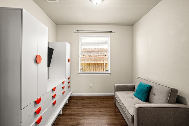 bedroom with dark hardwood / wood-style flooring